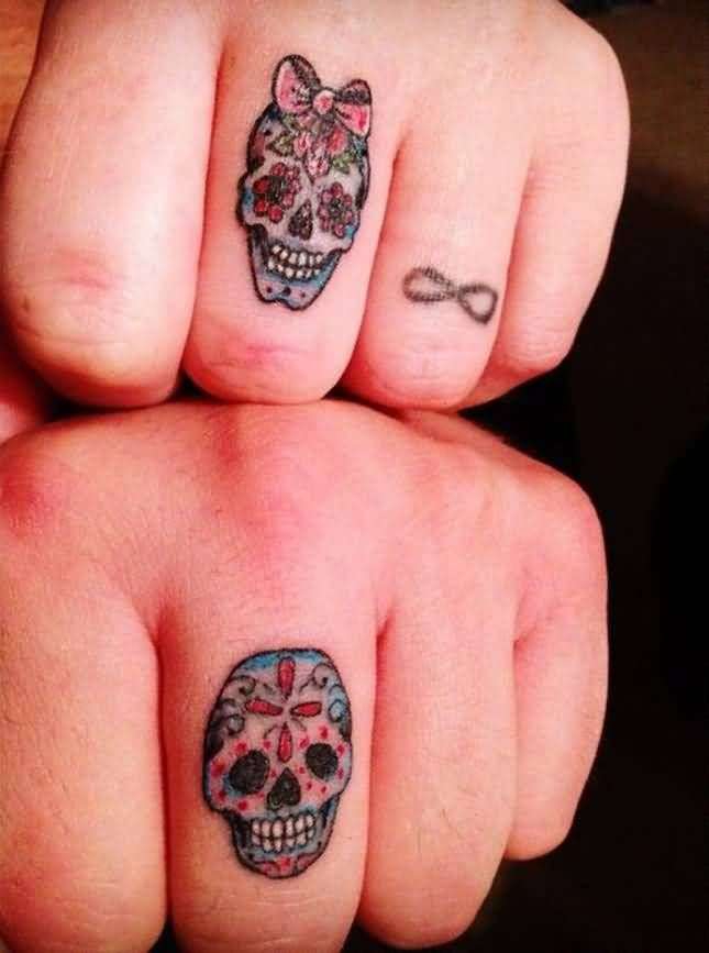 Tatuaje de calavera en pareja dedos