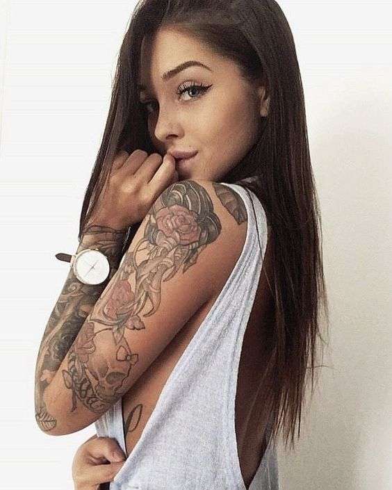 Chica sexi con tatuaje de rosas en el brazo