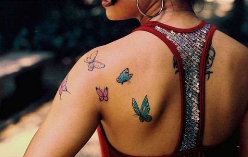 Tatuaje de mariposas en hombro y espalda